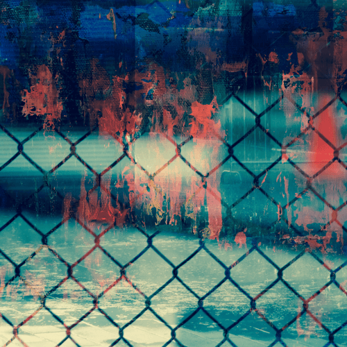 An abstract chain link fence with faces hazily hidden behind in abstract red hues